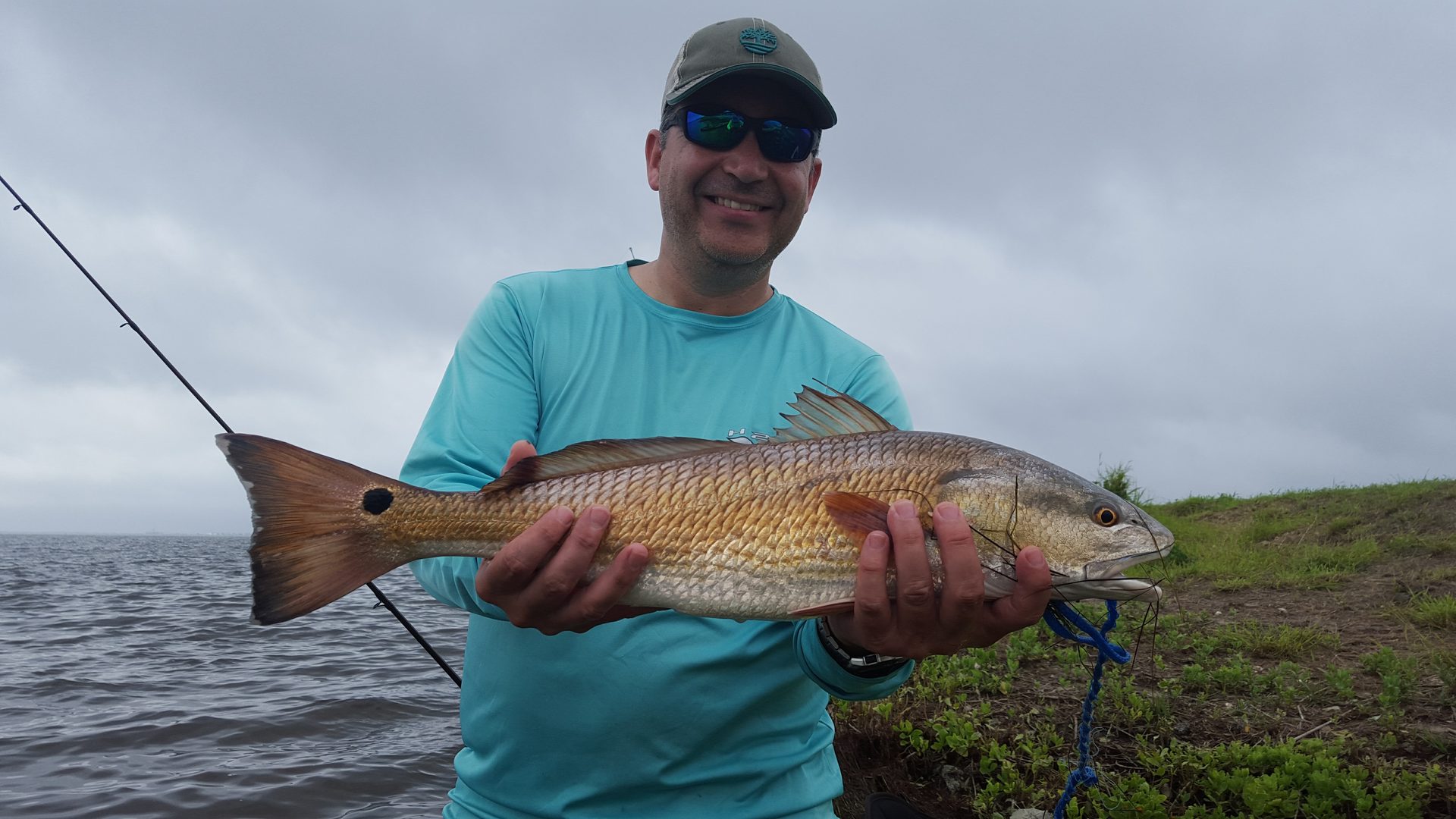 Angler holding a large redfish catch